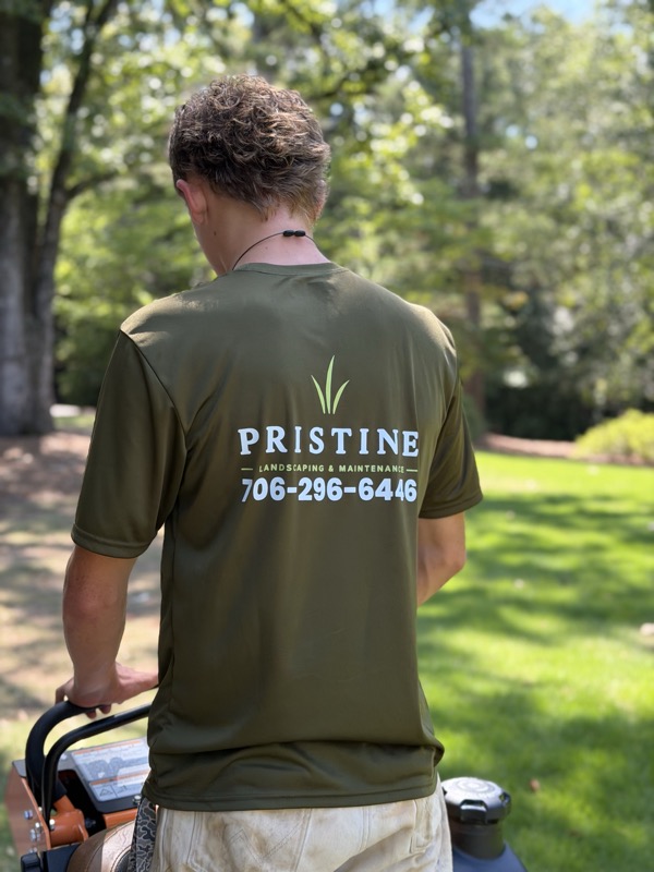Pristine Landscaping shirt from behind on a shaded lawn